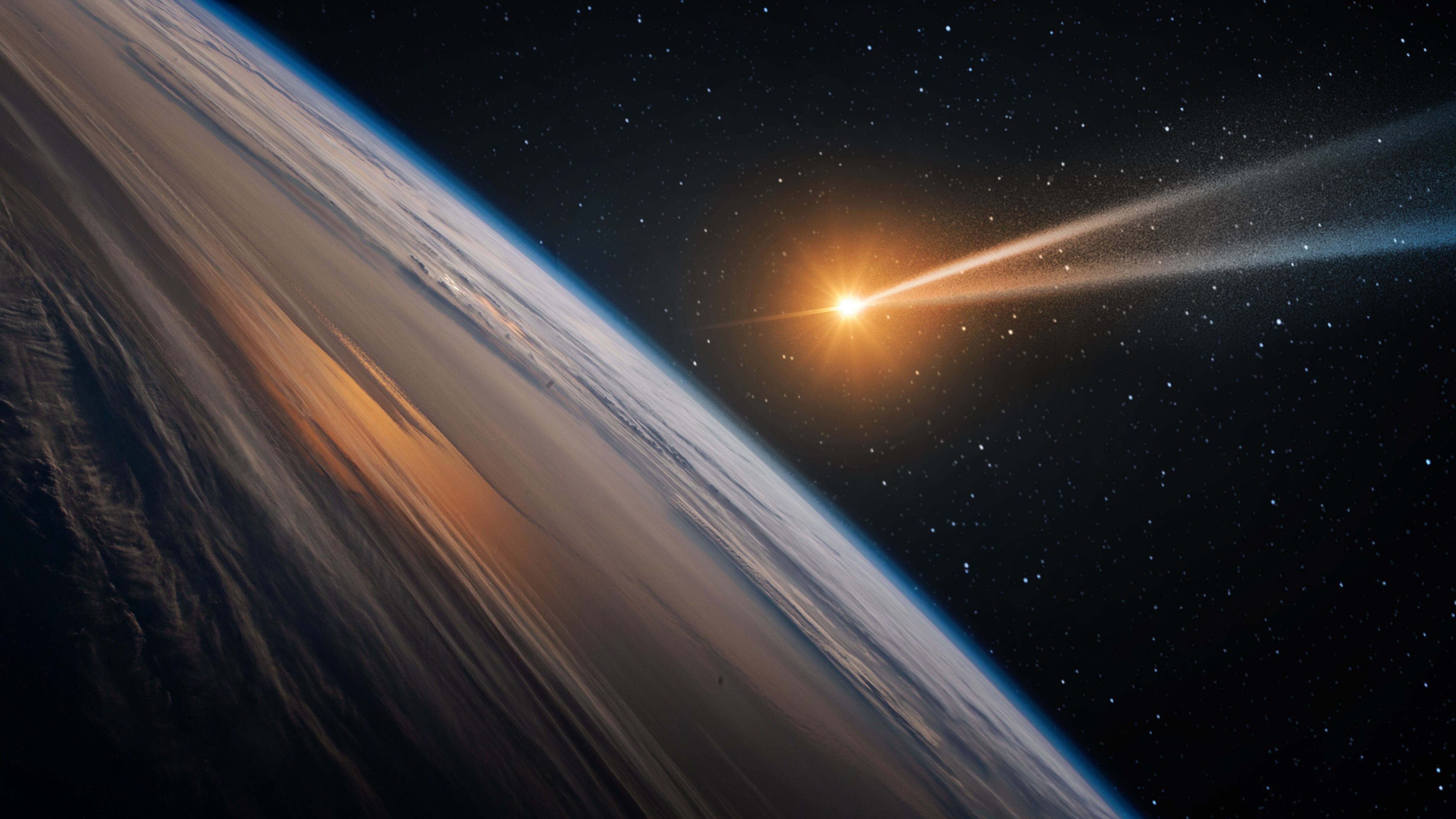 Comet, asteroid, meteorite flying to the planet Earth on the background of the starry night sky. Glowing asteroid and tail of a falling comet. Elements of this image furnished by NASA