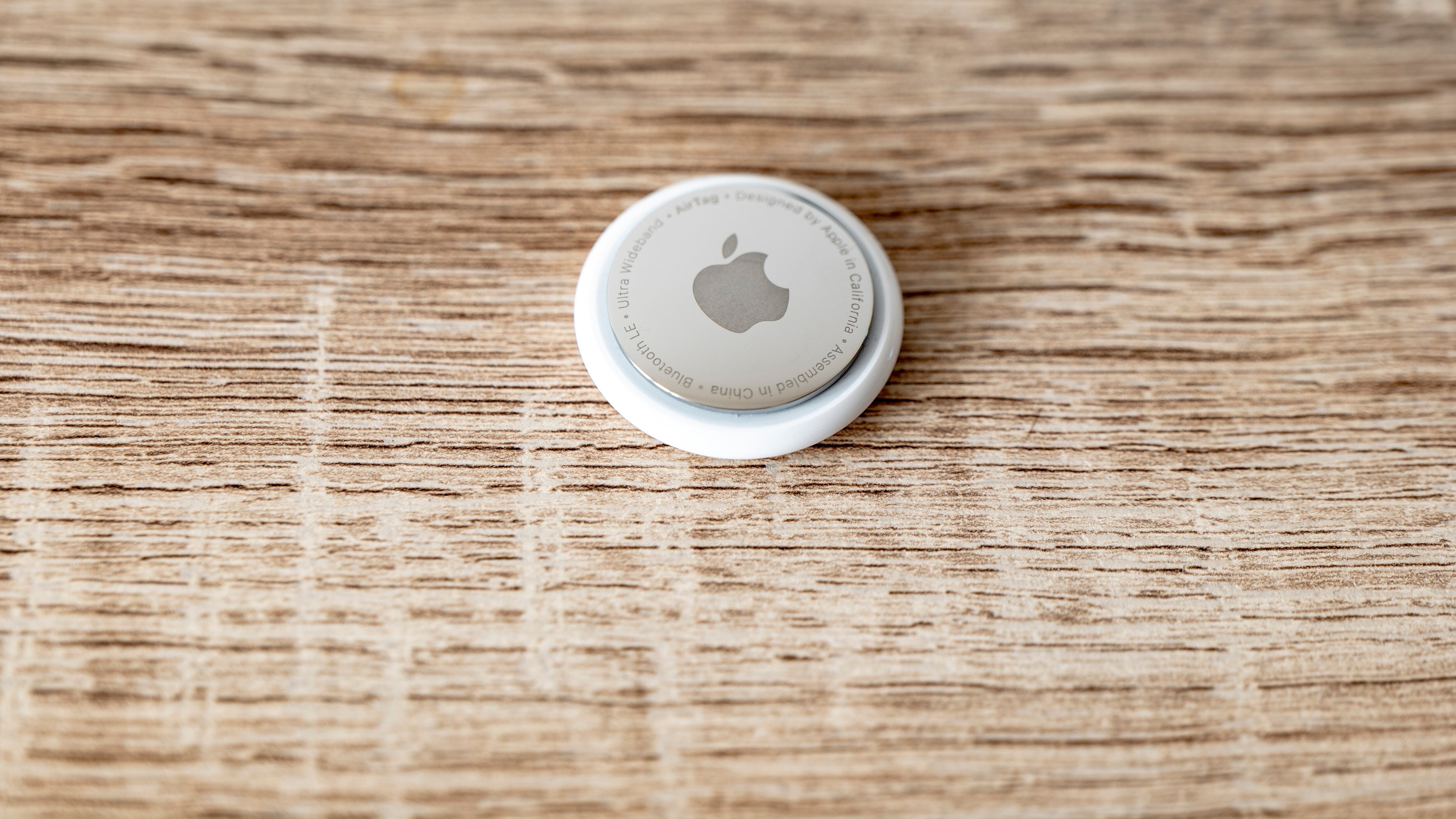 Apple AirTag tag on wooden surface for tracing lost items