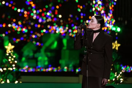 WASHINGTON, DC - NOVEMBER 30: St. Vincent performs "O Christmas Tree" during the Lighting Ceremony of the National Christmas Tree in President's Park in the Ellipse of the White House on November 30, 2023 in Washington, DC. High winds toppled the tree on Tuesday but workers were able to right the 40-foot Norway spruce, which was planted just two weeks ago to replace another tree, planted in 2021, that had developed a fungal disease. (Photo by Nathan Howard/Getty Images)